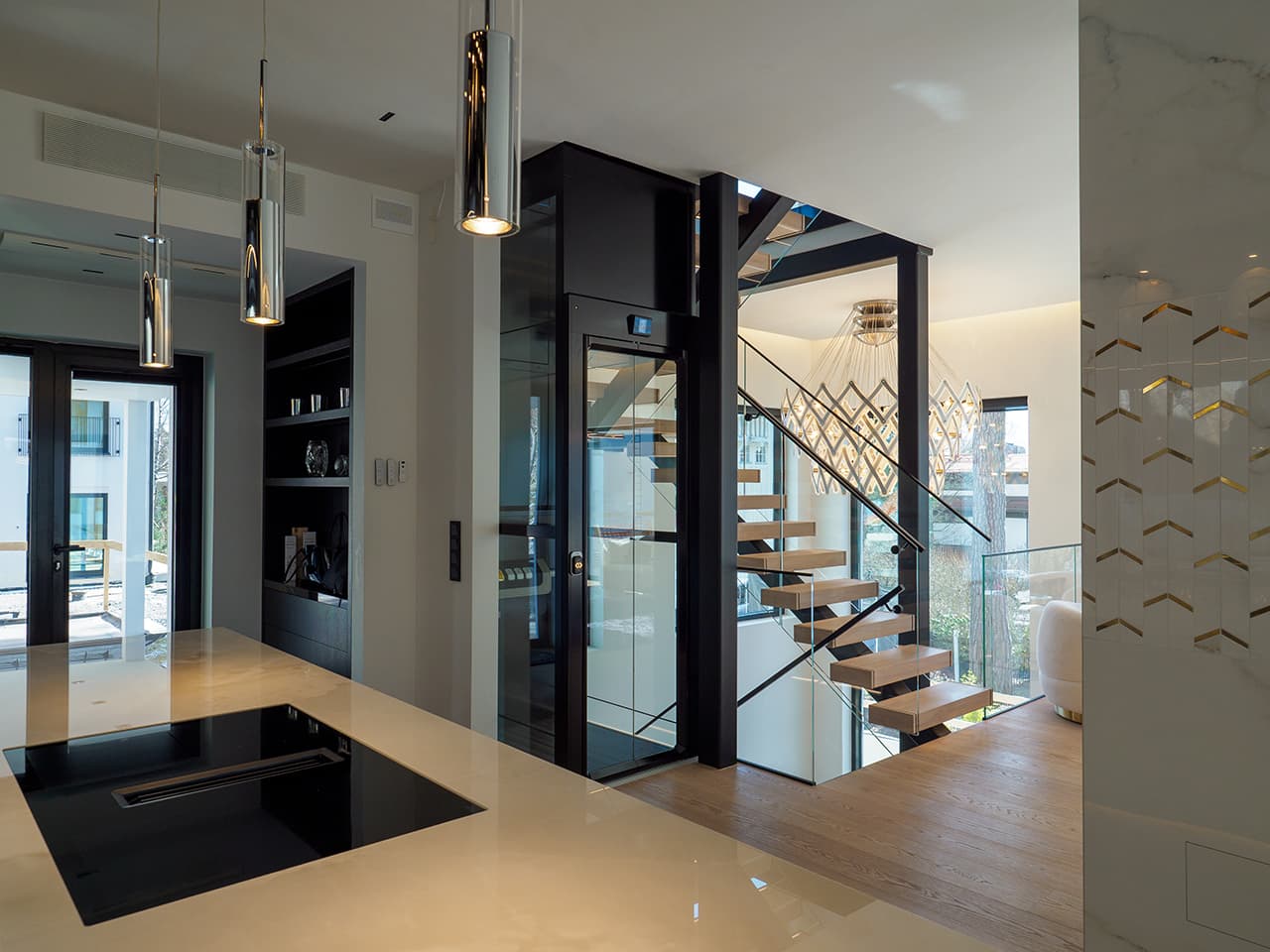 Black platform lift installed in a staircase, view from the top floor.