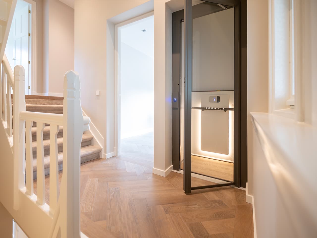 Black and white Cibes Air platform lift with a minimalist design in an enclosed shaft