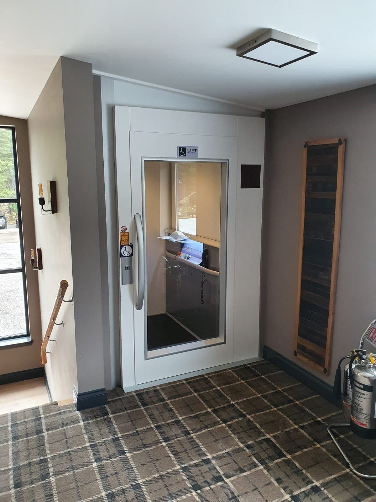 Lift built around stairs