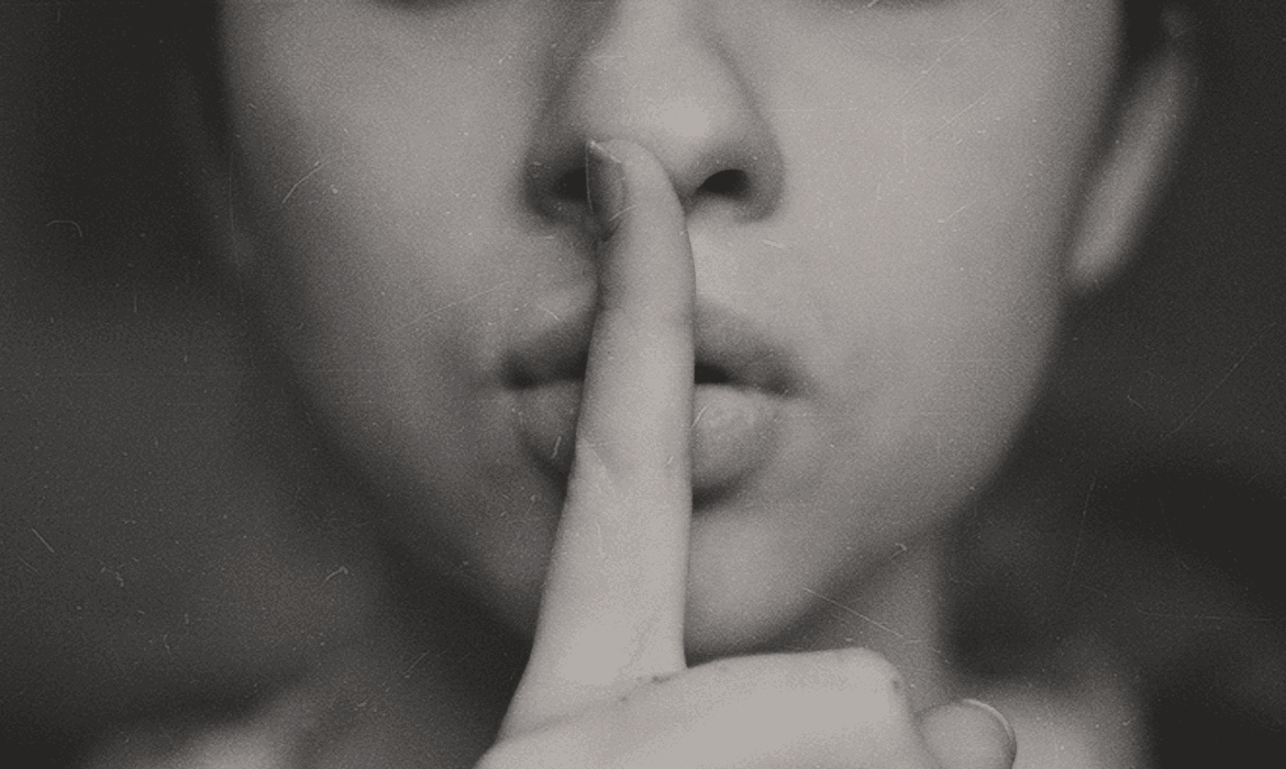 finger to mouth 'silence' photo